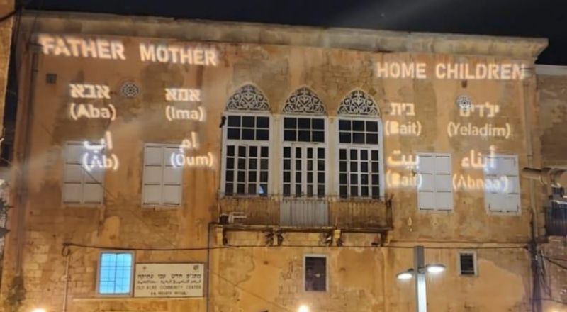 اضاءة مبنى المركز الجماهيري عبود التاريخي بكلمات ترمز الى الترابط العائلي وانتماء السكان لمدينة عكا.